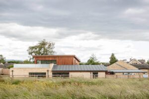 new build with costwold stone and cedar cladding